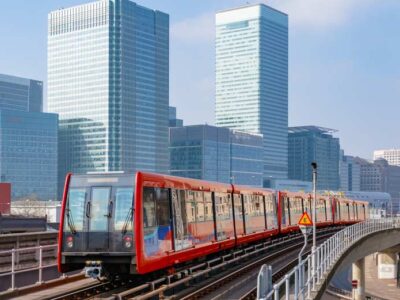 DLR Explained. Docklands Light Railway in London with Canary Wharf in the background