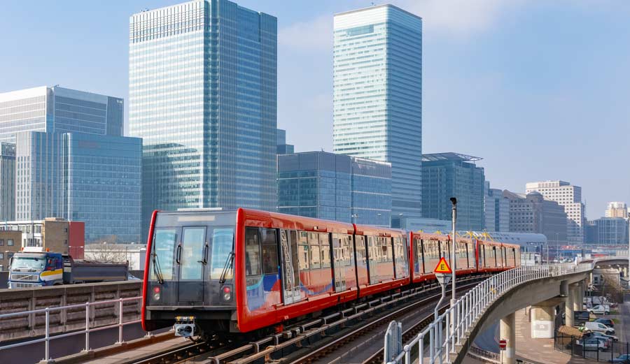 DLR Explained. Docklands Light Railway in London with Canary Wharf in the background